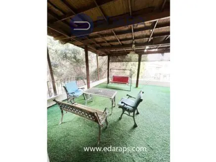 Furnished living room opening onto a landscaped private rooftop terrace in Degla Maadi
