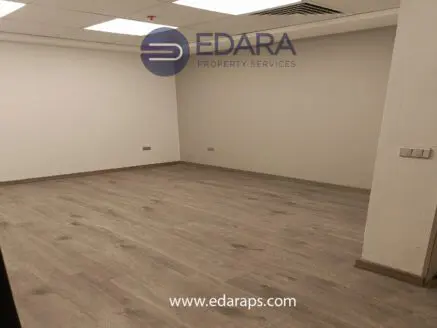 Empty interior space with light wooden flooring and white walls, featuring the Edara Property Services logo.