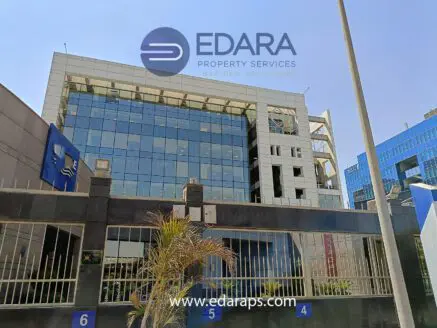 Modern office building with glass facade and Edara Property Services logo in Cairo.