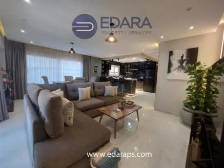 Contemporary living room featuring a gray sectional sofa, decorative pillows, and a coffee table.