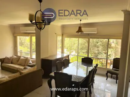 Spacious living room and dining area with large windows allowing natural light to enter the space.
