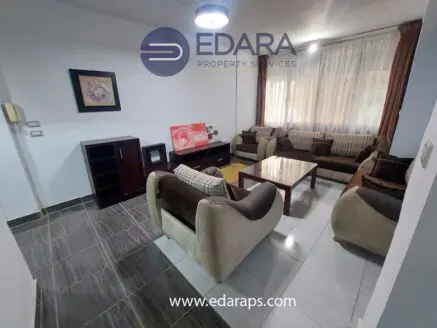 Modern living room featuring a sofa set, coffee table, and decorative wall art.