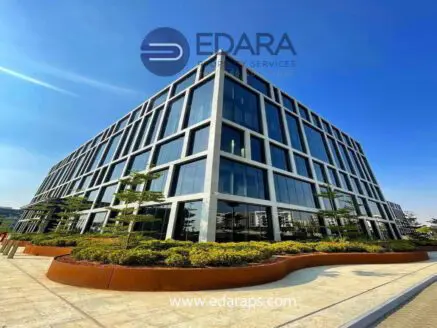 Contemporary office building featuring a glass facade and landscaped surroundings.