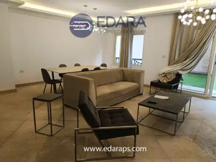 Contemporary living room featuring a beige sofa, black chairs, and a coffee table in a spacious layout.
