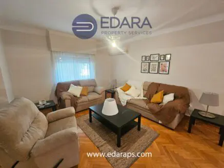 Cozy living room featuring two sofas, a coffee table, and wall art in a neutral color scheme.