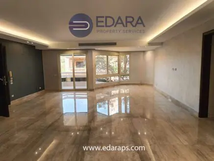 Interior view of a spacious residential property with marble flooring and large windows.