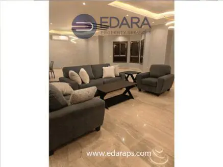 Gray sofa set with cushions and a coffee table in a modern living room setting.