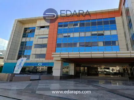 Exterior view of a modern office building with large windows and a colorful facade.
