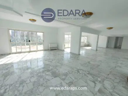 Bright interior space featuring marble flooring and large windows allowing natural light.
