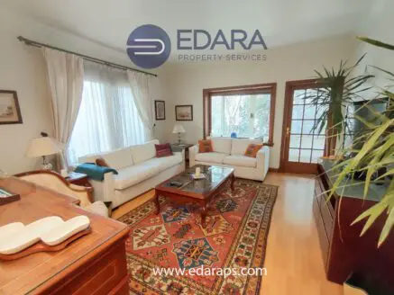 Cozy living room featuring a white sofa, coffee table, and decorative rug.
