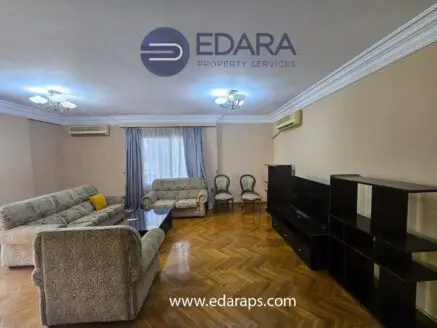 Living room featuring two sofas, a coffee table, and a television unit against a wall.
