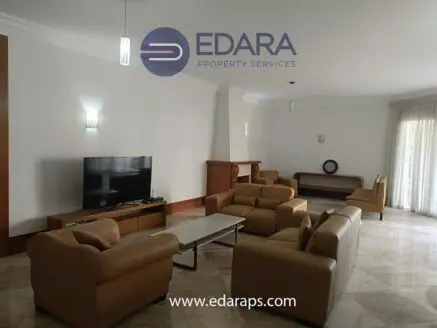 Living room featuring leather sofas, a television, and a coffee table in a modern interior design.