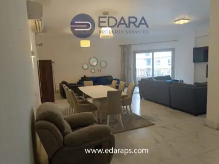 Spacious living room and dining area with a large table and comfortable seating in a contemporary style.
