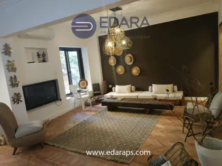 Modern living room featuring a wooden coffee table, comfortable seating, and decorative wall elements.