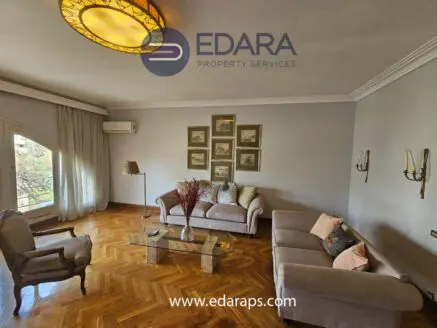 Living room featuring two sofas, a coffee table, and wall art in a neutral color scheme.
