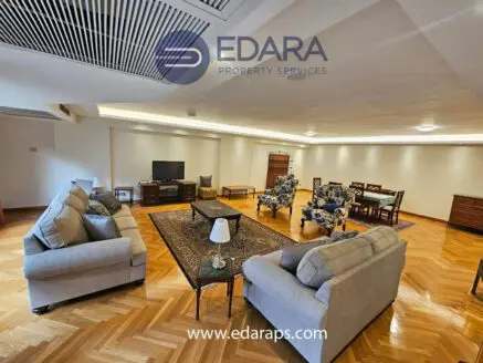 Interior view of a spacious living room featuring sofas, chairs, and a coffee table.