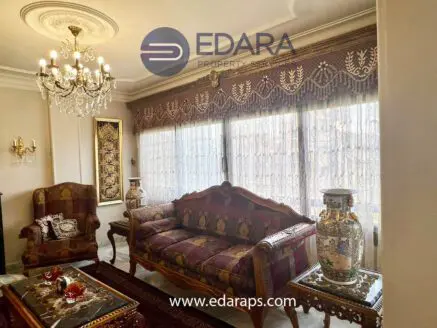 Elegant traditional living room furniture set with ornate details and decorative elements.