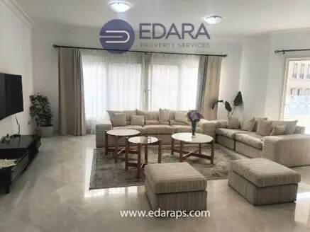 Spacious modern living room featuring a large sectional sofa and multiple coffee tables.