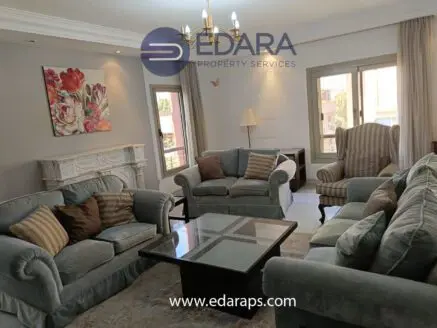 Living room featuring a set of plush sofas, an armchair, and a coffee table in a well-lit space.