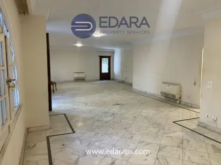 Spacious empty room featuring marble flooring and neutral wall colors, suitable for various interior designs.