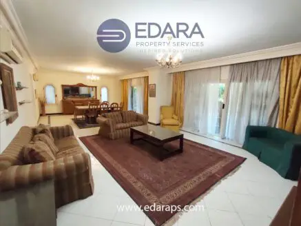 Spacious living room featuring a sofa set, coffee table, and decorative rug.