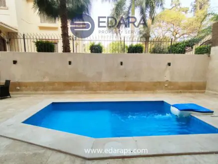 Octagonal swimming pool with clear blue water and a white float in a residential setting.