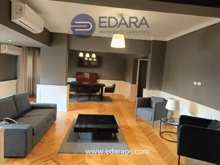 Contemporary living room featuring a gray sofa, coffee table, and decorative lighting in a stylish interior design.