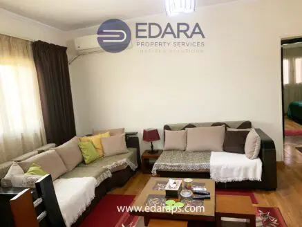 Living room featuring a sofa set with decorative cushions and a coffee table in a residential setting.