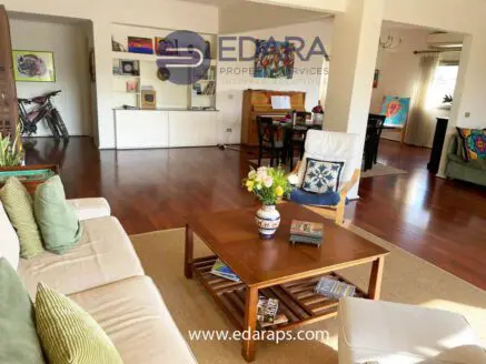 Interior view of a living room featuring a coffee table, sofa, and decorative elements.