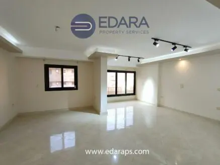 Bright empty room with large windows and polished marble flooring in a modern design.