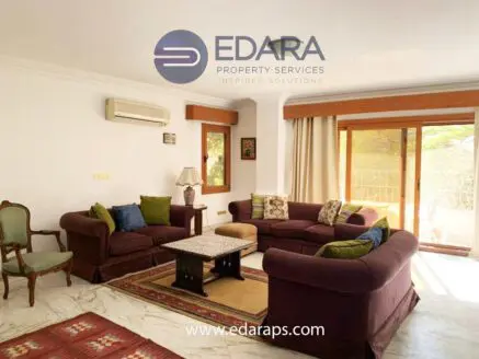 Living room featuring a sofa set with cushions and a coffee table in a bright indoor space.