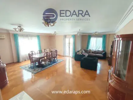 Spacious living room featuring a dining table and seating area with large windows for natural light.