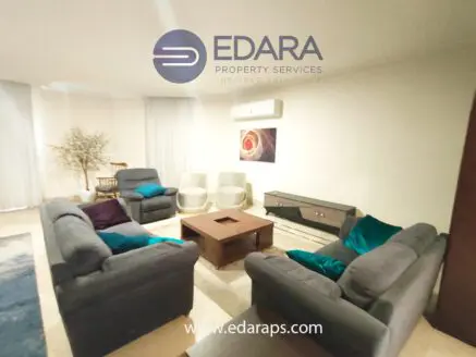 Living room featuring gray sofas, a wooden coffee table, and decorative elements.