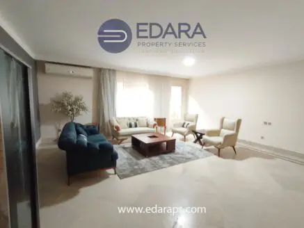 Modern living room featuring a blue sofa, beige armchairs, and a coffee table on a light-colored rug.