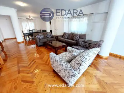 Living room featuring a gray sofa set and a coffee table on a wooden floor.