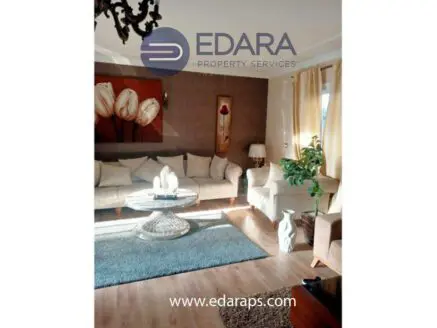 Modern living room featuring a beige sofa, glass coffee table, and decorative elements.