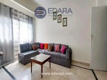Living room featuring a gray sectional sofa with colorful cushions and a wooden coffee table.