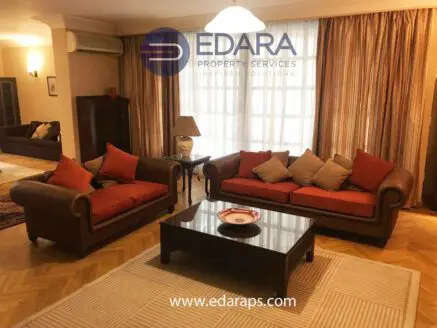 Living room featuring two brown sofas with orange cushions and a wooden coffee table.