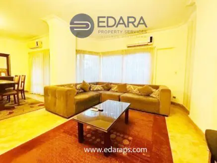 Cozy living room featuring a large brown sectional sofa and a glass coffee table on a patterned rug.