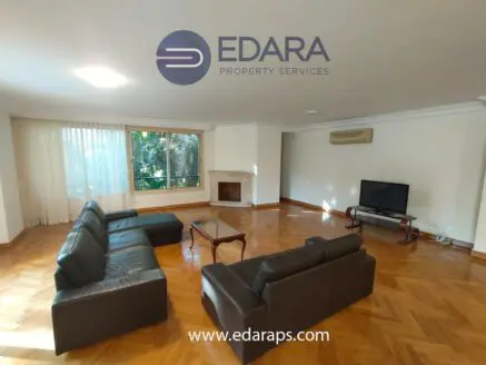Living room featuring a leather sofa set, wooden coffee table, and television in a well-lit space.