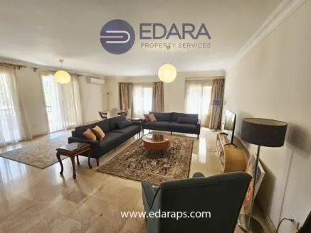 Living room featuring two large sofas, a coffee table, and natural light from windows.