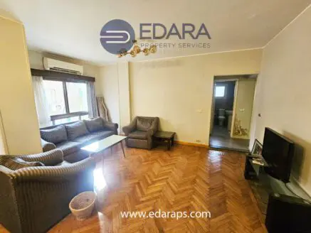 Living room featuring a sofa set, coffee table, and television in a residential setting.