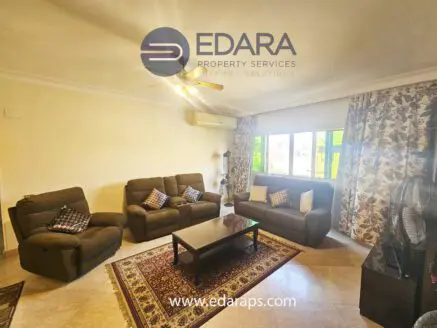Living room featuring a brown sofa set, coffee table, and decorative curtains in a neutral color scheme.