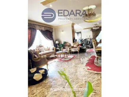 Elegant living room featuring plush seating, decorative curtains, and a marble floor.