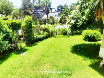 A well-maintained garden featuring lush green grass and various plants, providing a natural landscape.