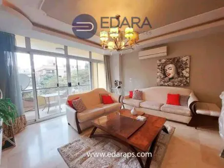 Modern living room featuring a beige sofa, wooden coffee table, and decorative artwork on the wall.