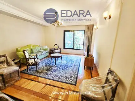 Classic living room with green sofa and wooden chairs – Edara Property Services