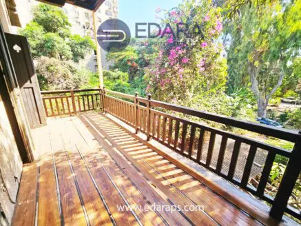 Balcony with wooden flooring and garden view – Edara Property Services
