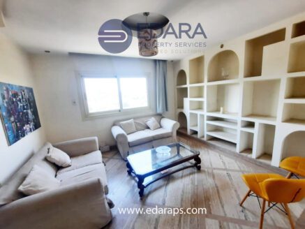 Small lounge with sofas, built-in shelves, and window