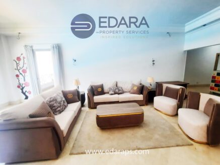Modern living room with beige sofas and central coffee table – Edara Property Services